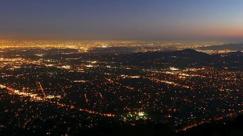 City lights at dusk seen from a hillside